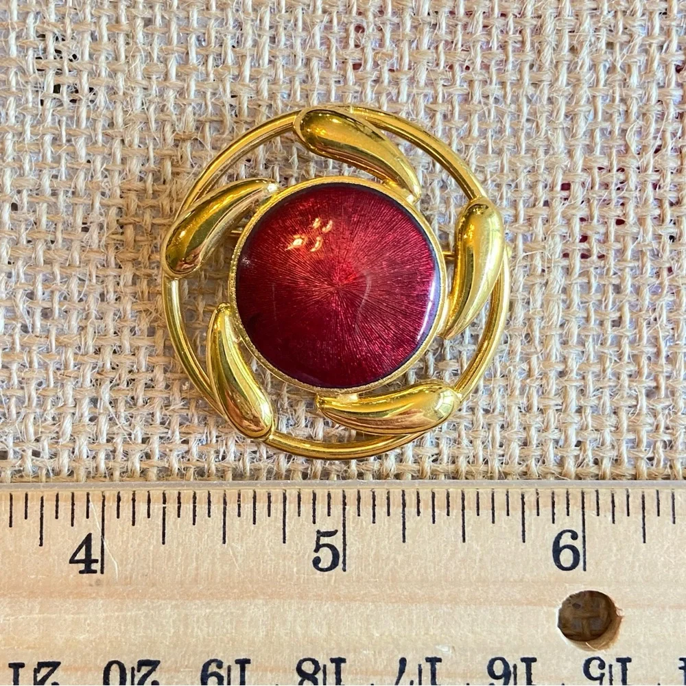 Convertible brooch and pendant circle with red enamel center in goldtone metal